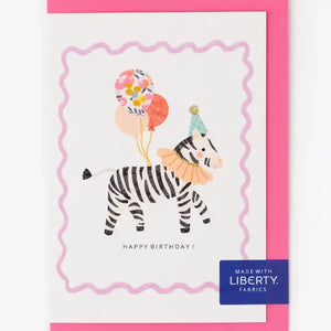 Funky zebra with Liberty Wiltshire bud balloon and glitter party hat on pink birthday card