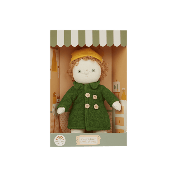 Olli Ella Dress Me Dinky Charlie Chestnut doll in green trench coat and yellow beanie, ready for imaginative adventures.