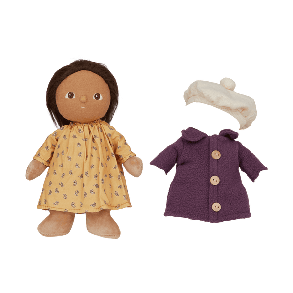 Olli Ella Dress Me Dinky doll in a yellow dress with a purple coat and white beanie, ready for adventure.