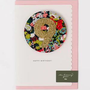 Glittery birthday badge featuring number 9 on floral Liberty Thorpe card with pink envelope, perfect for age 9 celebrations.