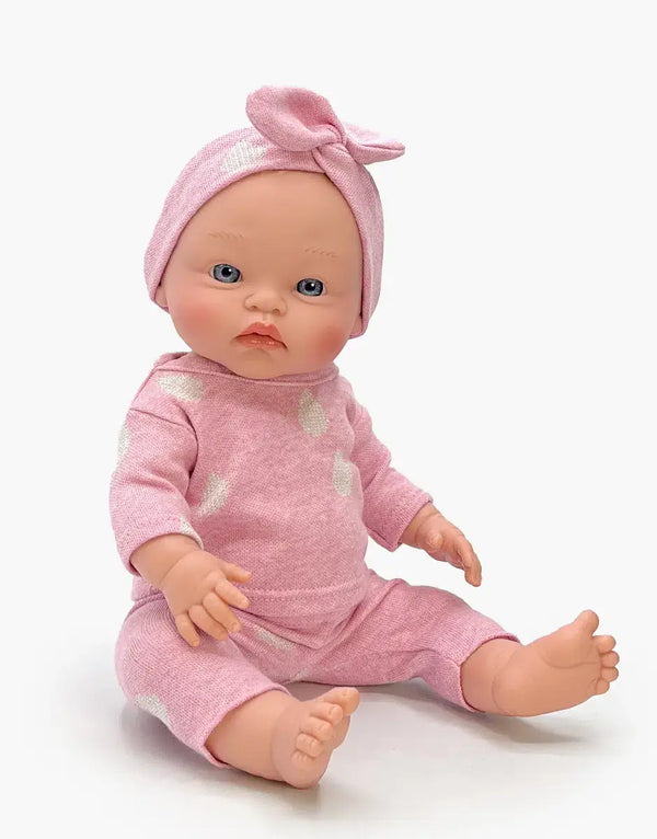 Minikane Cuties Iris doll in pink sleepsuit and headband, featuring blue eyes, perfect for kids 3 years and up.